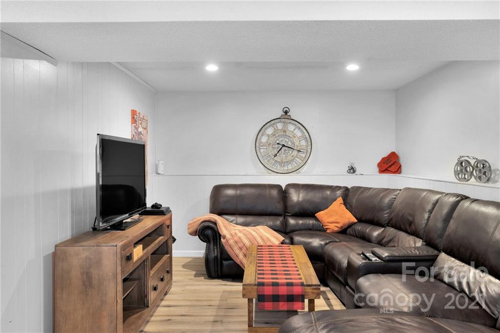 4800 Cheviot Road Charlotte, NC 28269 - Photo 26 of 34 a living room with furniture and a flat screen tv