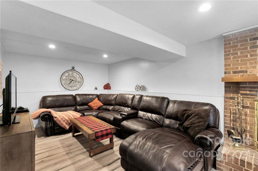 4800 Cheviot Road Charlotte, NC 28269 - Photo 27 of 34 a living room with furniture and a fireplace