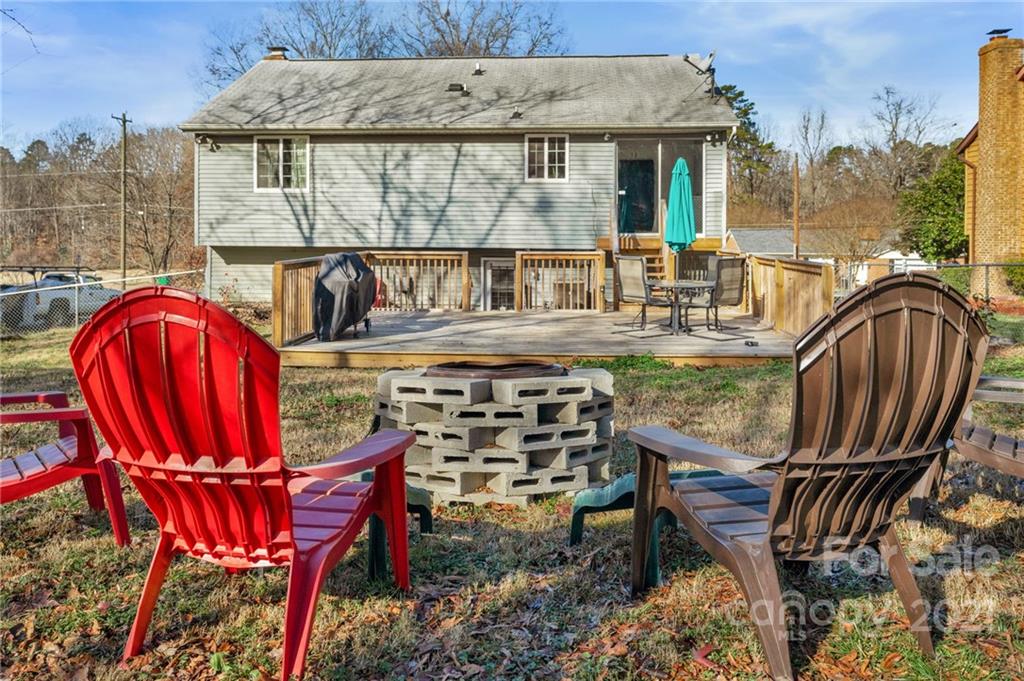 4800 Cheviot Road Charlotte, NC 28269 - Photo 30 of 34 a view of a patio with table and chairs with wooden floor and fence