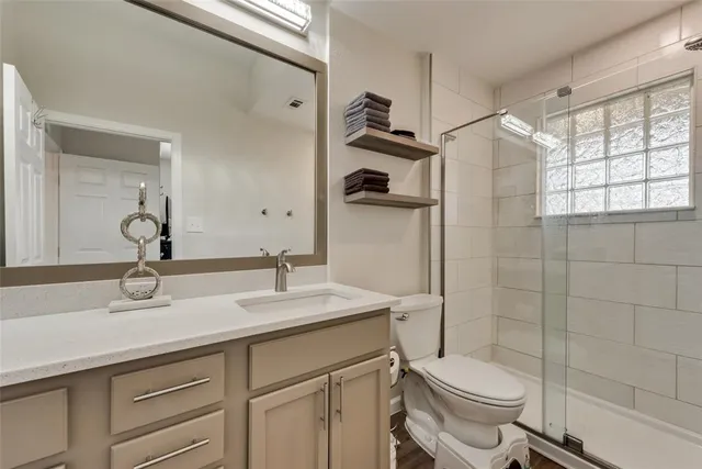a bathroom with a sink toilet and shower
