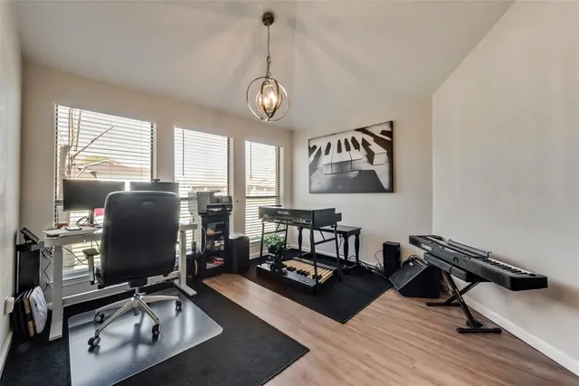 a view of a workspace with furniture and a window