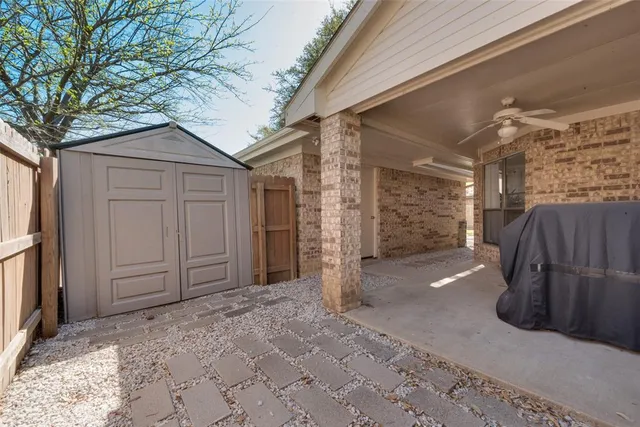 a view of a house with a wooden fence