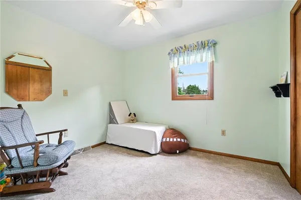 a bathroom with a granite countertop sink a toilet and a mirror