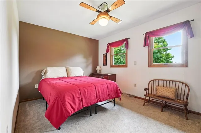a living room with furniture and a book shelf