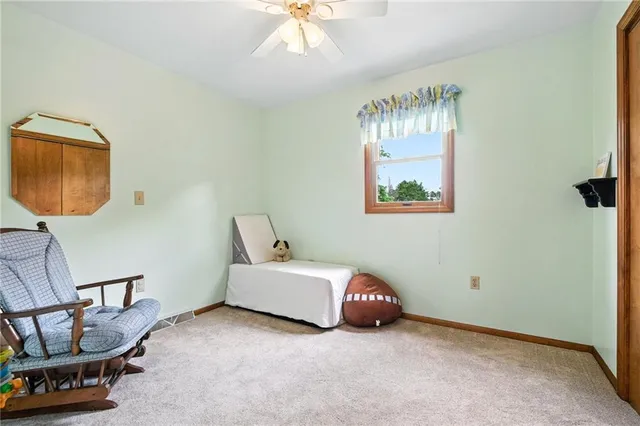 a bathroom with a granite countertop sink a toilet and a mirror
