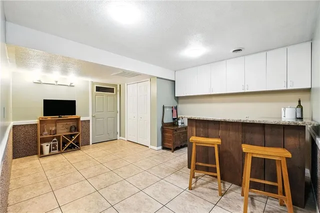 a kitchen with granite countertop a refrigerator and cabinets