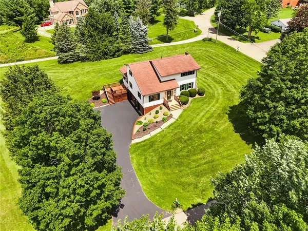 an aerial view of a house with a garden and swimming pool