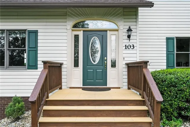 a front view of a house with a garden