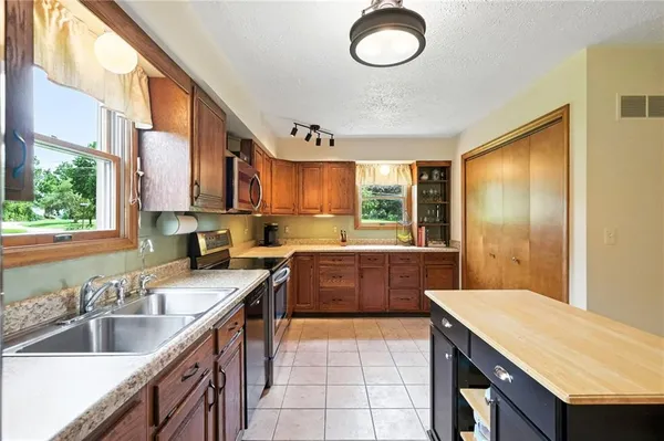 a kitchen with a sink stove and cabinets