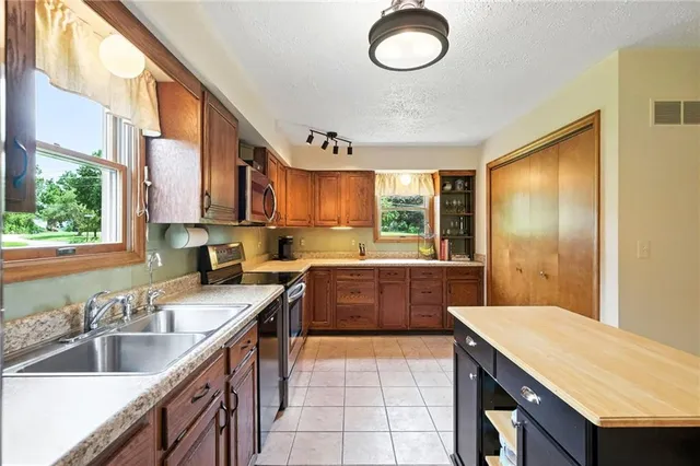 a kitchen with a sink stove and cabinets