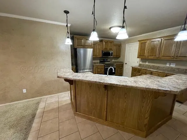 a kitchen with a sink a counter top space cabinets and stainless steel appliances
