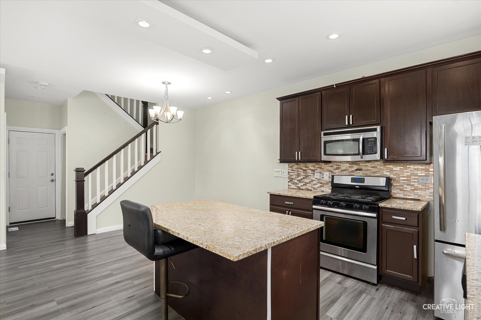 179 Azalea Circle, Unit 179 Romeoville, IL 60446 - Photo 4 of 16 a kitchen with a stove a sink and a microwave