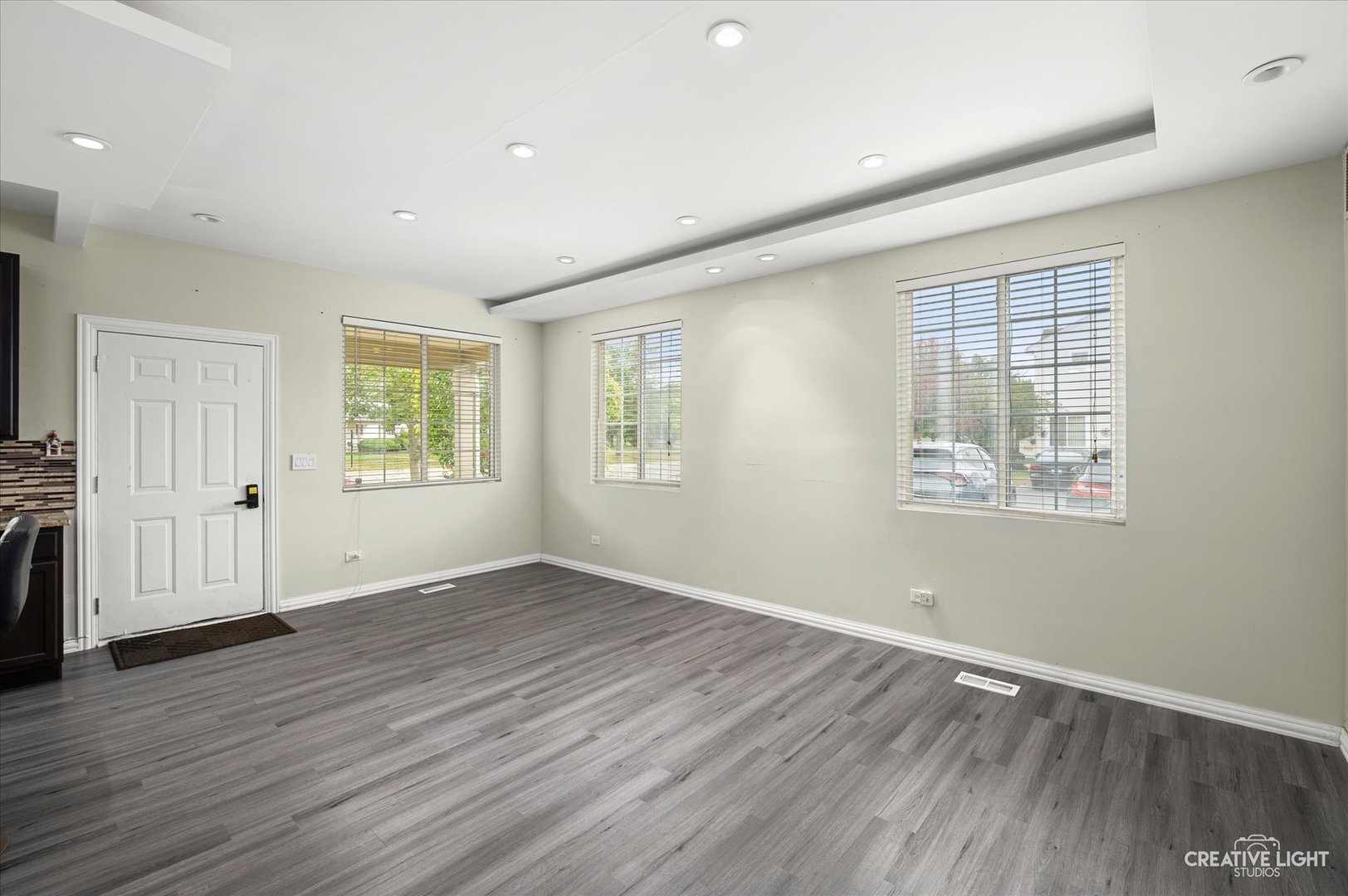 179 Azalea Circle, Unit 179 Romeoville, IL 60446 - Photo 6 of 16 an empty room with wooden floor and windows