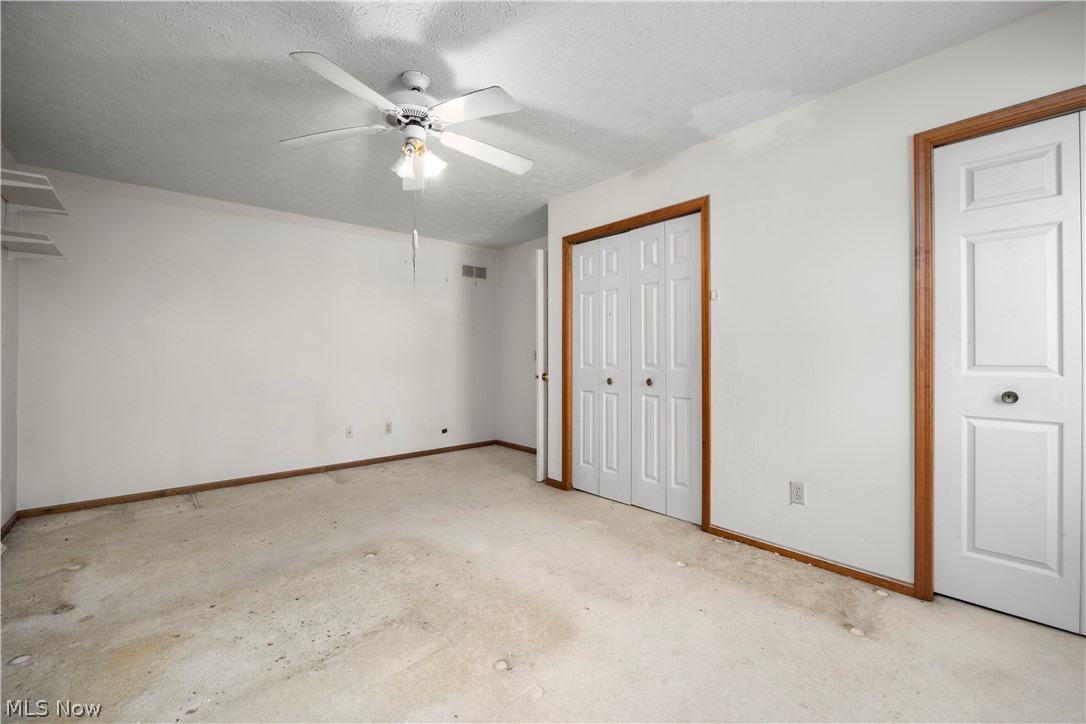 722 Jaycox Road Avon Lake, OH 44012 - Photo 31 of 48 Room featuring a ceiling fan with integrated lighting, wood trim, and 2 built-in closet with bi-fold doors