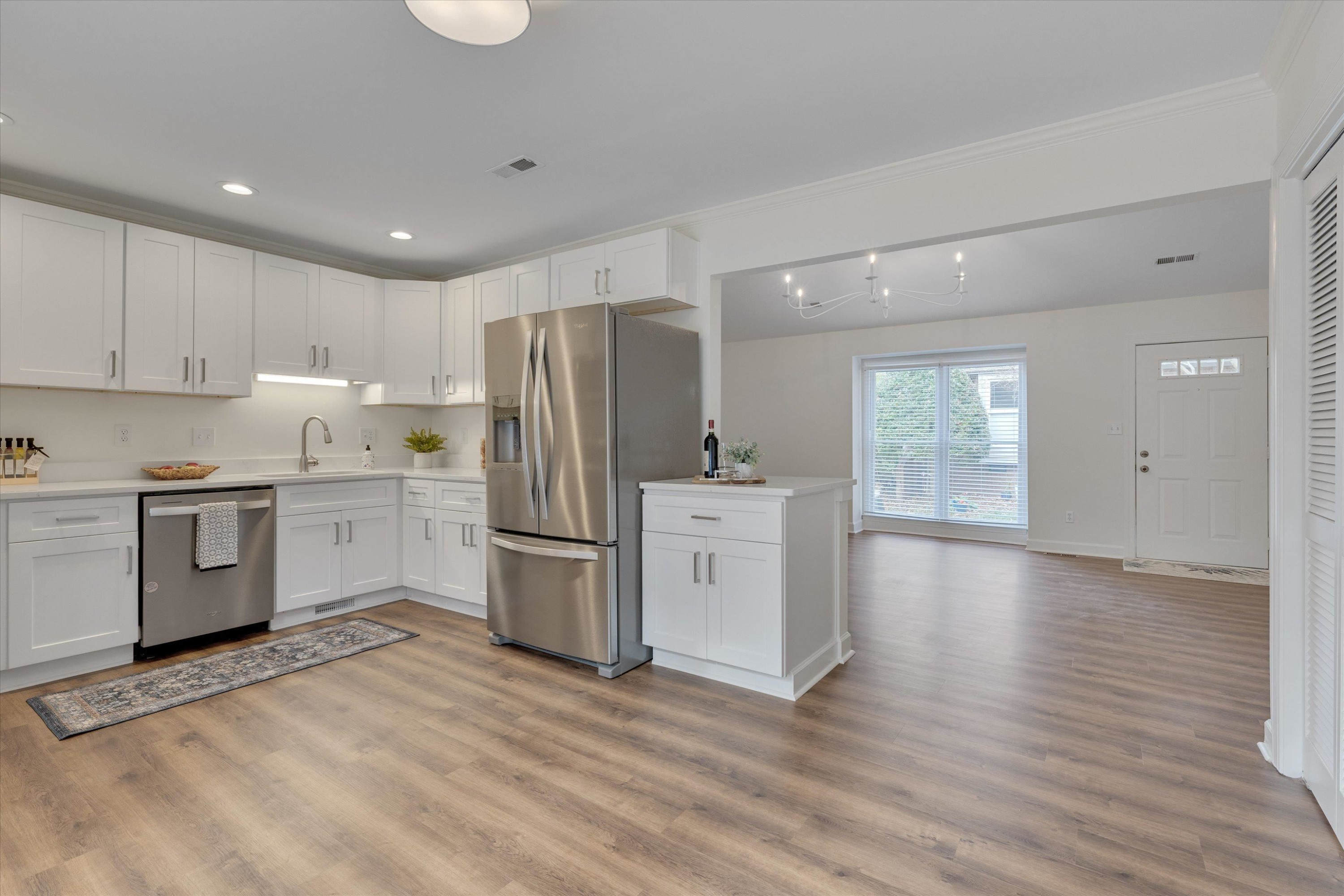 5500 Fortunes Ridge Drive, Unit 106D Durham, NC 27713 - Photo 12 of 30 a kitchen with a refrigerator a stove top oven and white cabinets