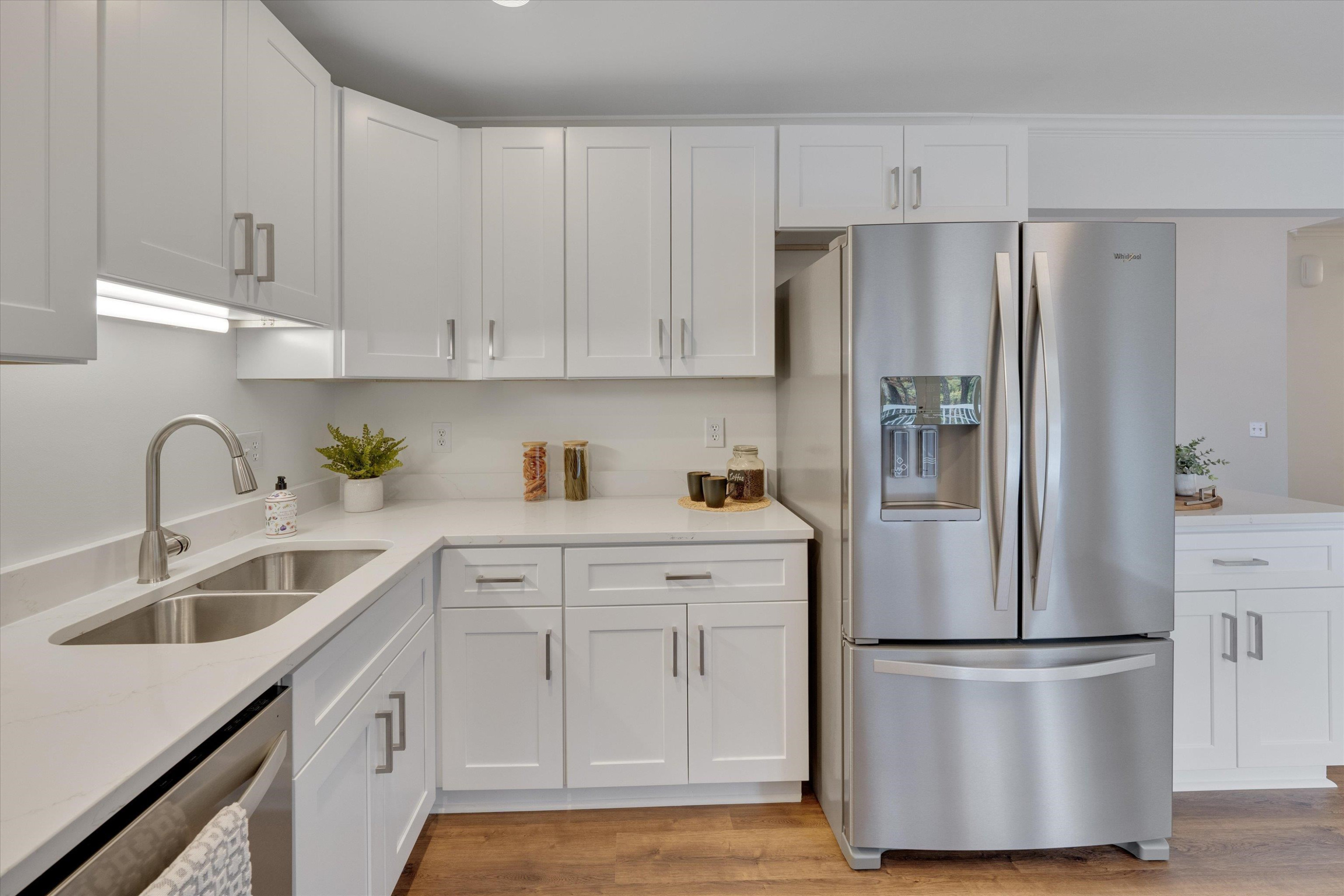 5500 Fortunes Ridge Drive, Unit 106D Durham, NC 27713 - Photo 15 of 30 a kitchen with appliances a refrigerator a sink and cabinets