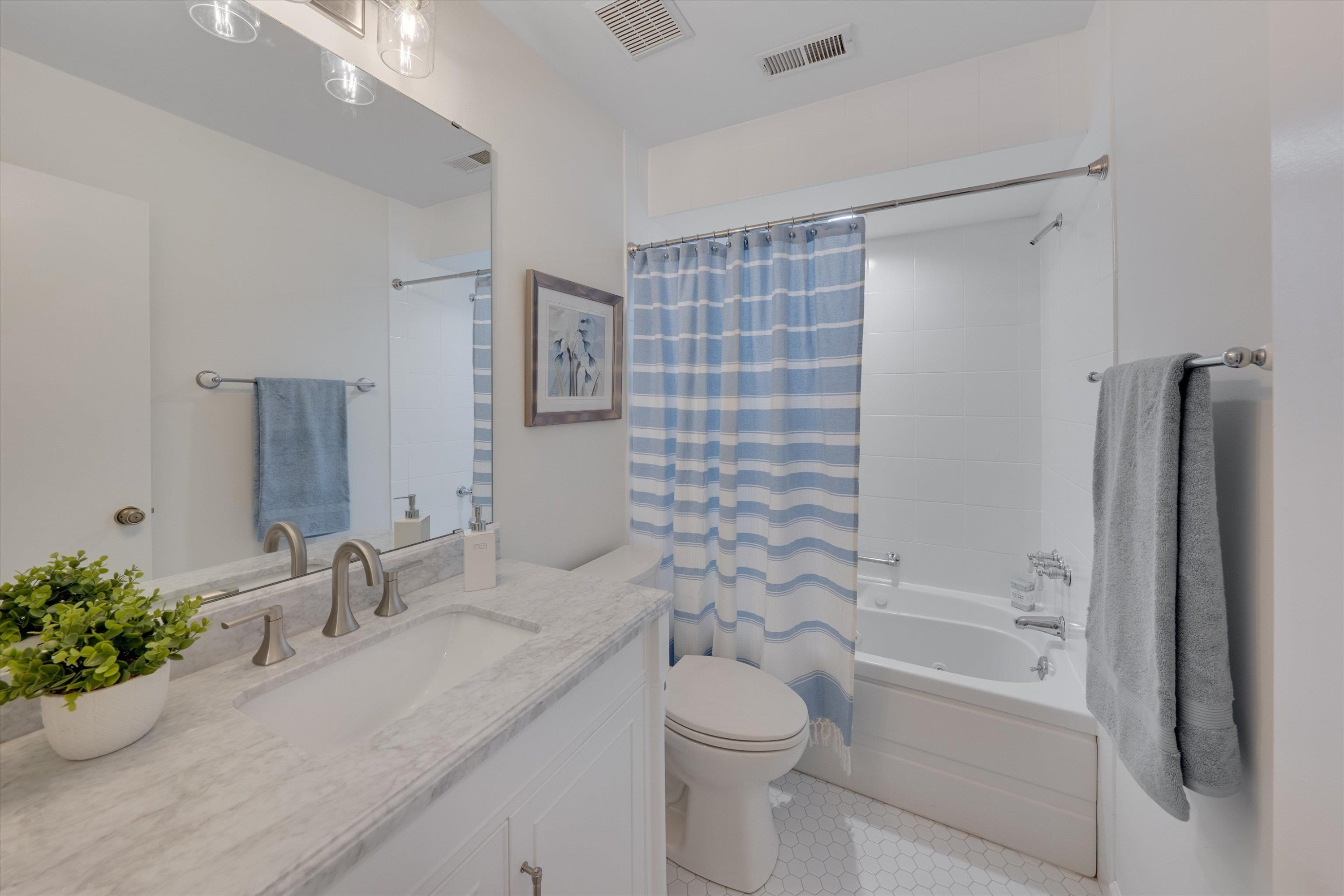 5500 Fortunes Ridge Drive, Unit 106D Durham, NC 27713 - Photo 17 of 30 a bathroom with a granite countertop sink a toilet and shower