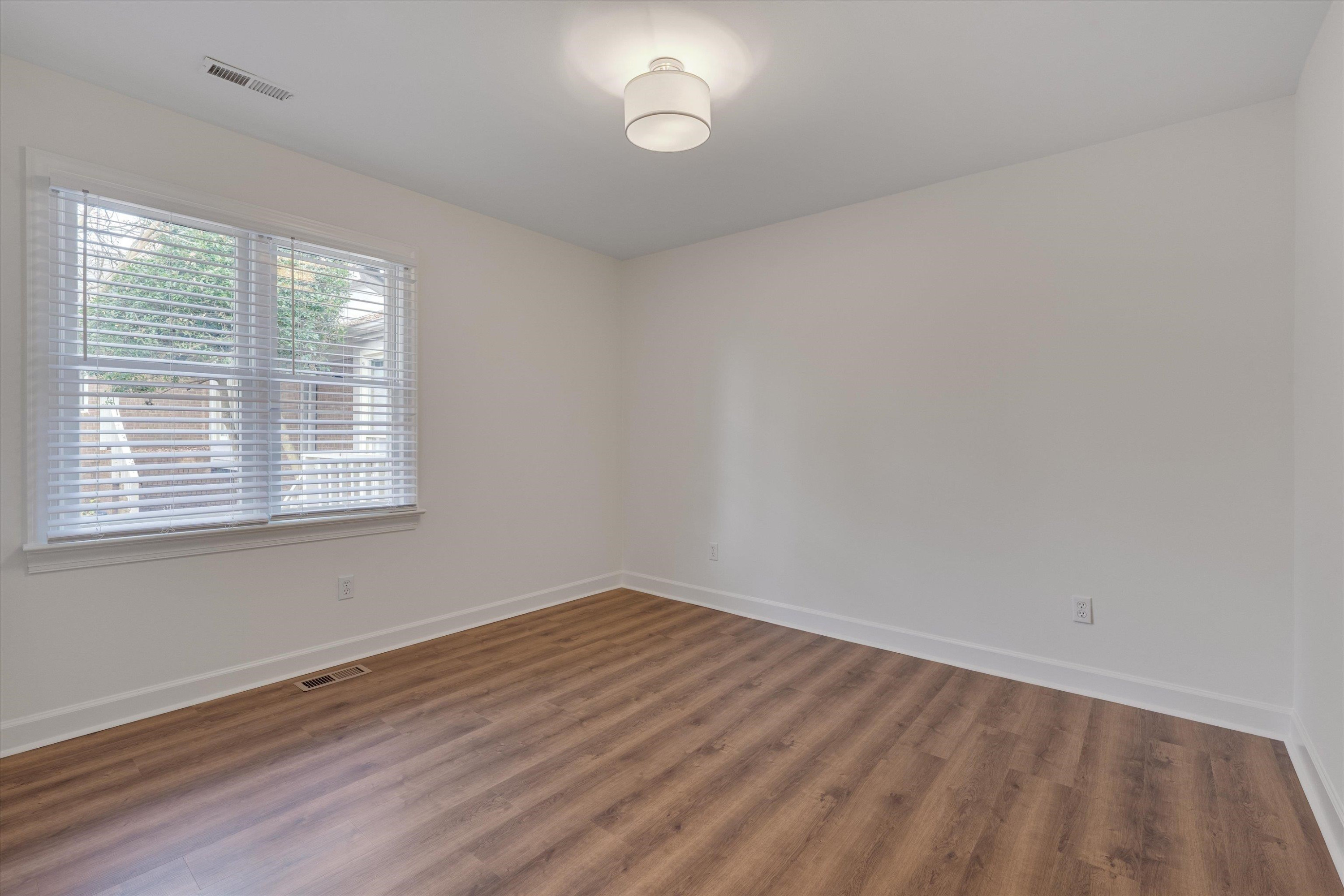 5500 Fortunes Ridge Drive, Unit 106D Durham, NC 27713 - Photo 18 of 30 wooden floor in an empty room with a window