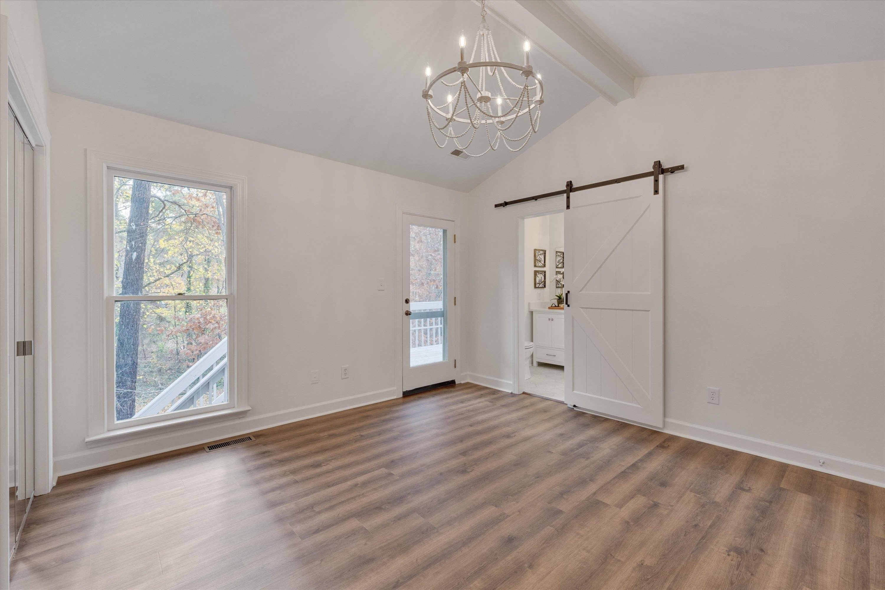 5500 Fortunes Ridge Drive, Unit 106D Durham, NC 27713 - Photo 21 of 30 a view of an empty room with wooden floor and a window