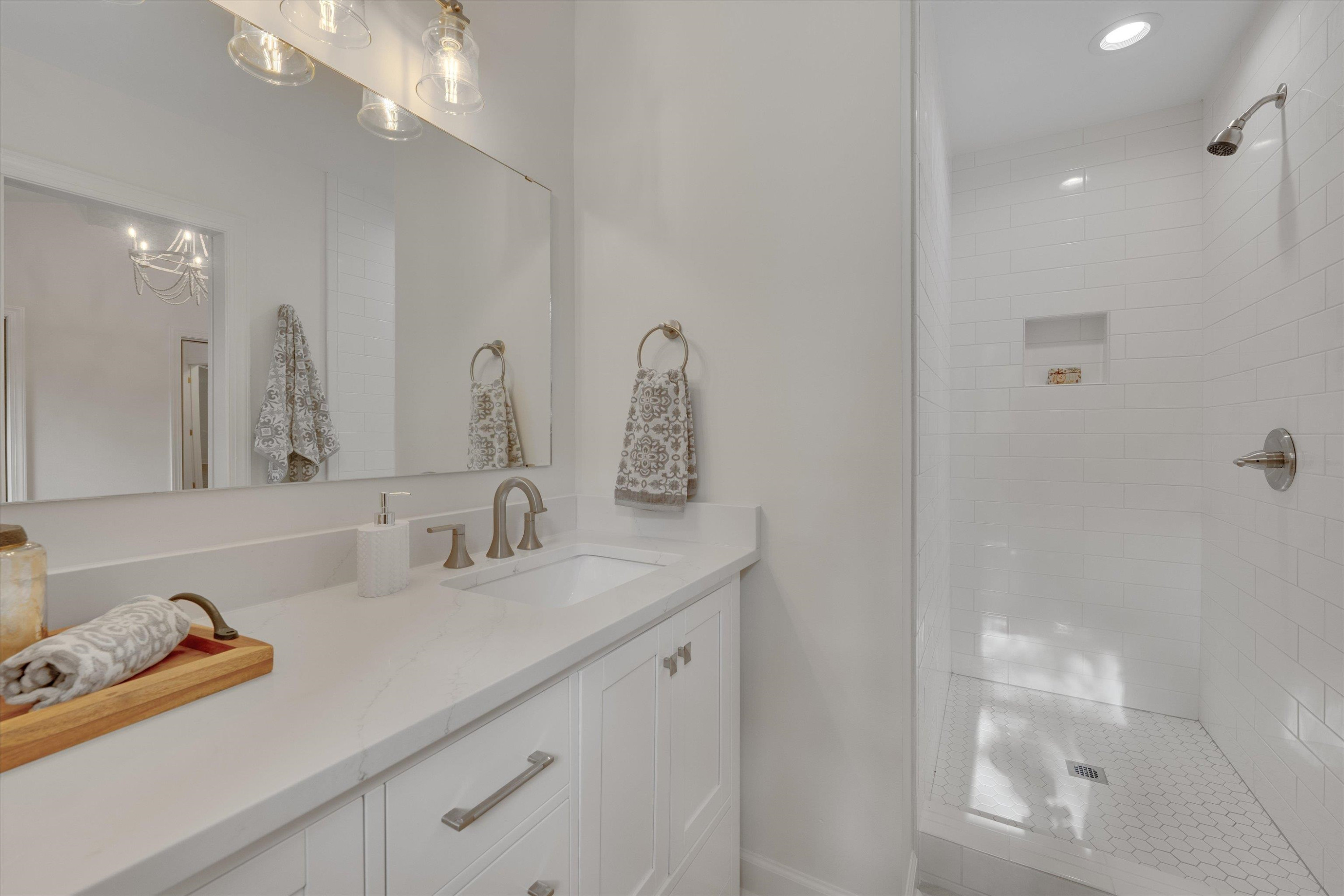 5500 Fortunes Ridge Drive, Unit 106D Durham, NC 27713 - Photo 24 of 30 a bathroom with a sink and a mirror