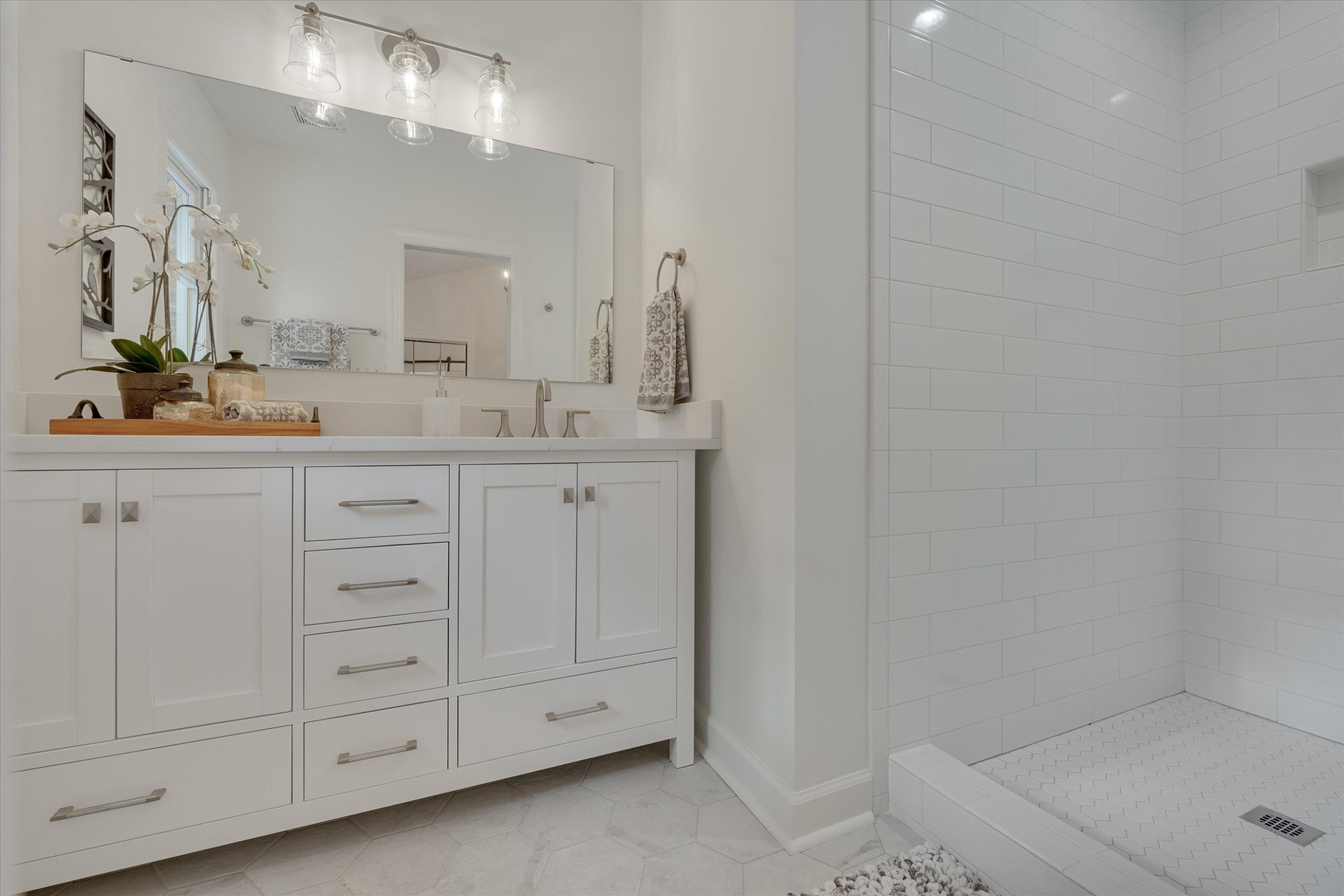 5500 Fortunes Ridge Drive, Unit 106D Durham, NC 27713 - Photo 25 of 30 a bathroom with a sink a vanity and a mirror