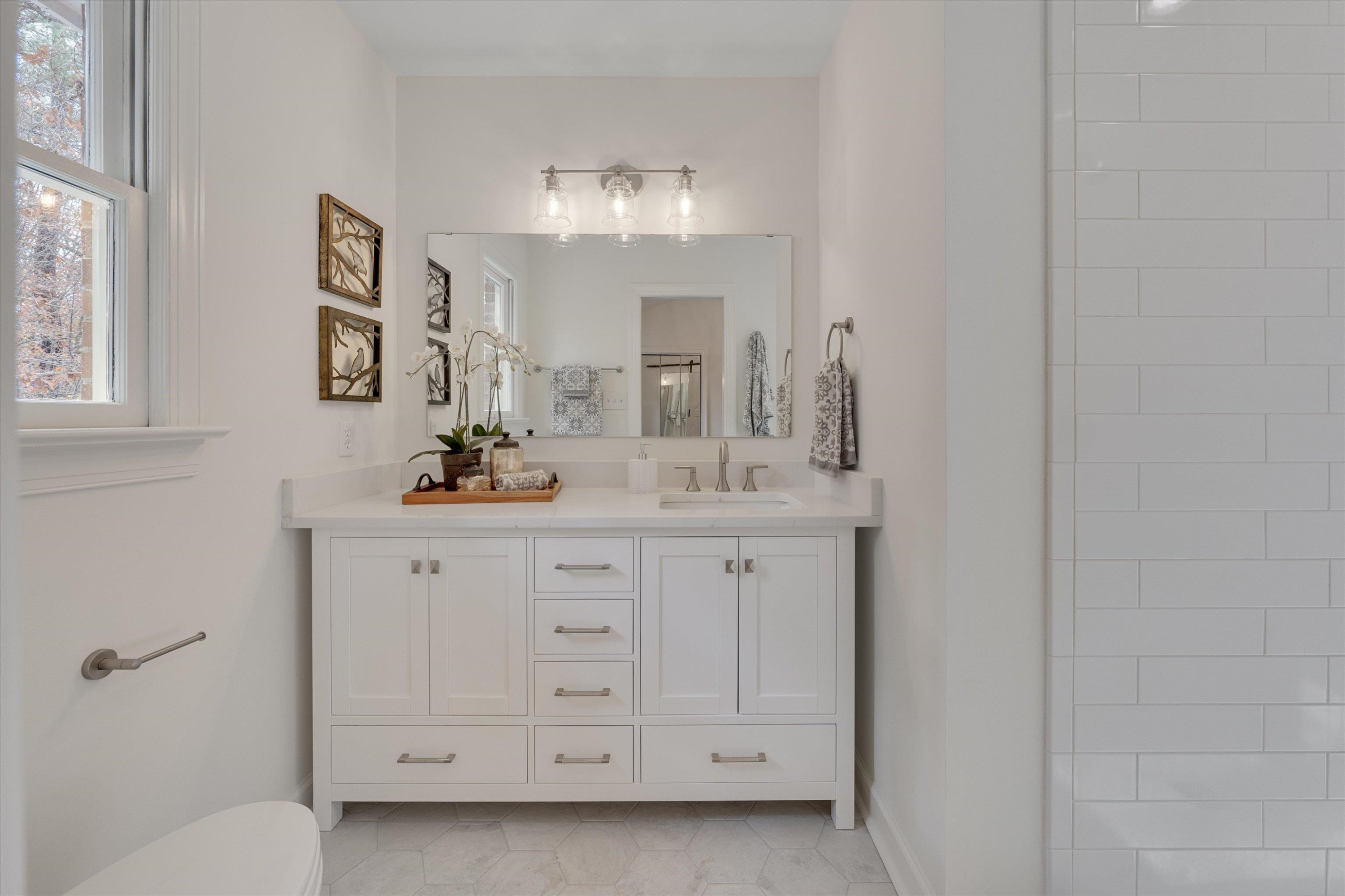 5500 Fortunes Ridge Drive, Unit 106D Durham, NC 27713 - Photo 26 of 30 a bathroom with a double vanity sink a mirror and a