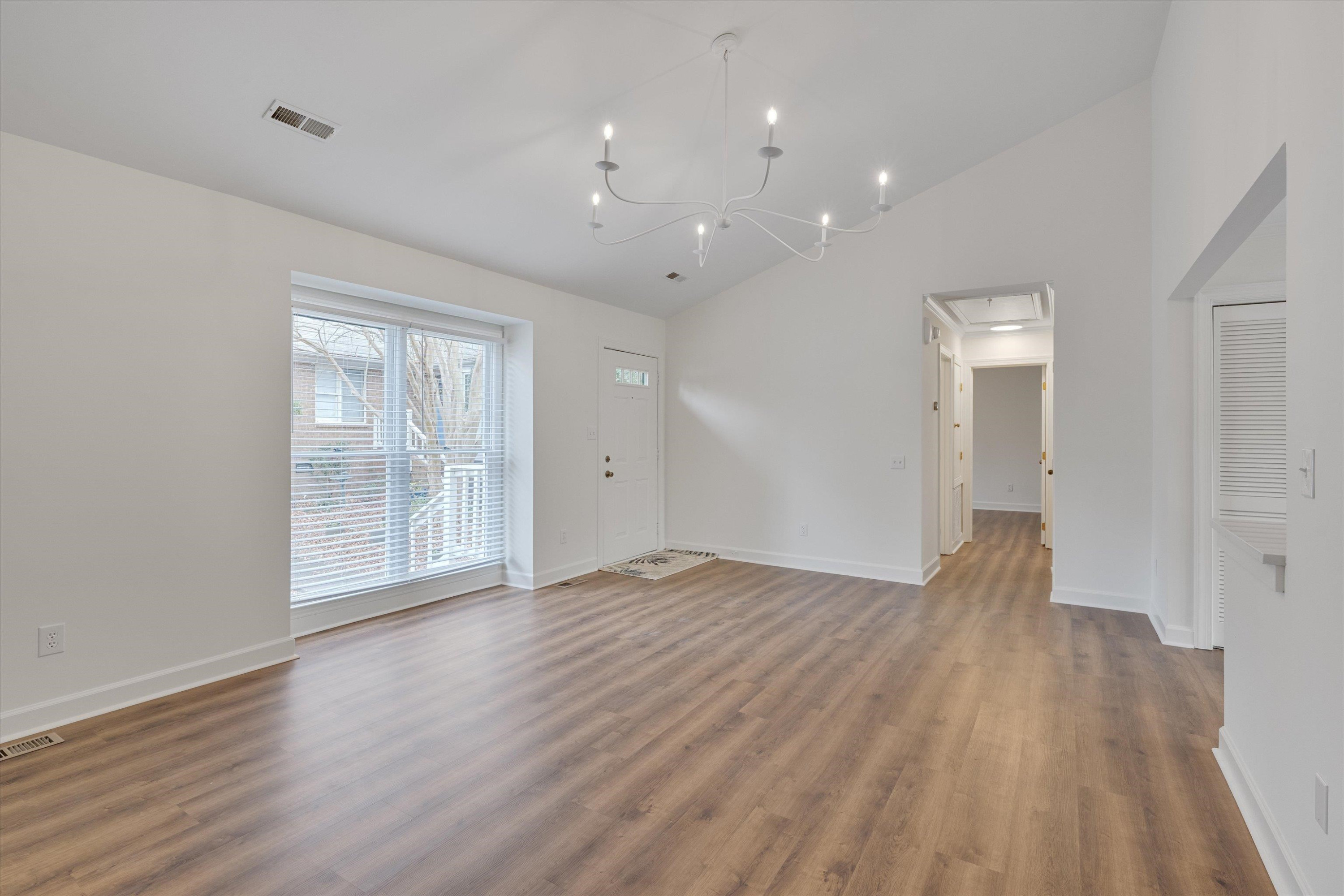 5500 Fortunes Ridge Drive, Unit 106D Durham, NC 27713 - Photo 7 of 30 wooden floor in an empty room with a window