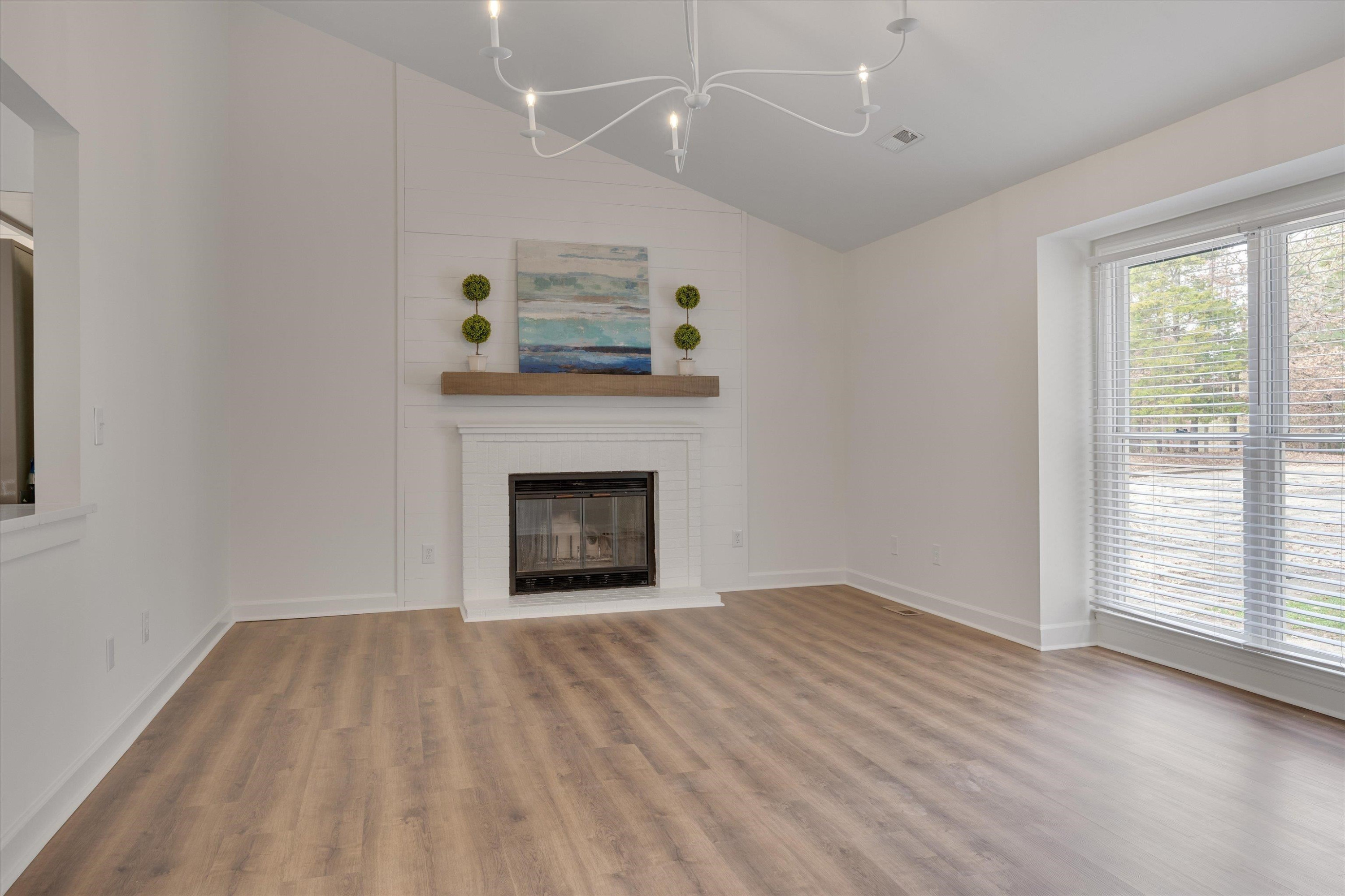 5500 Fortunes Ridge Drive, Unit 106D Durham, NC 27713 - Photo 8 of 30 a view of an empty room with a fireplace and a window