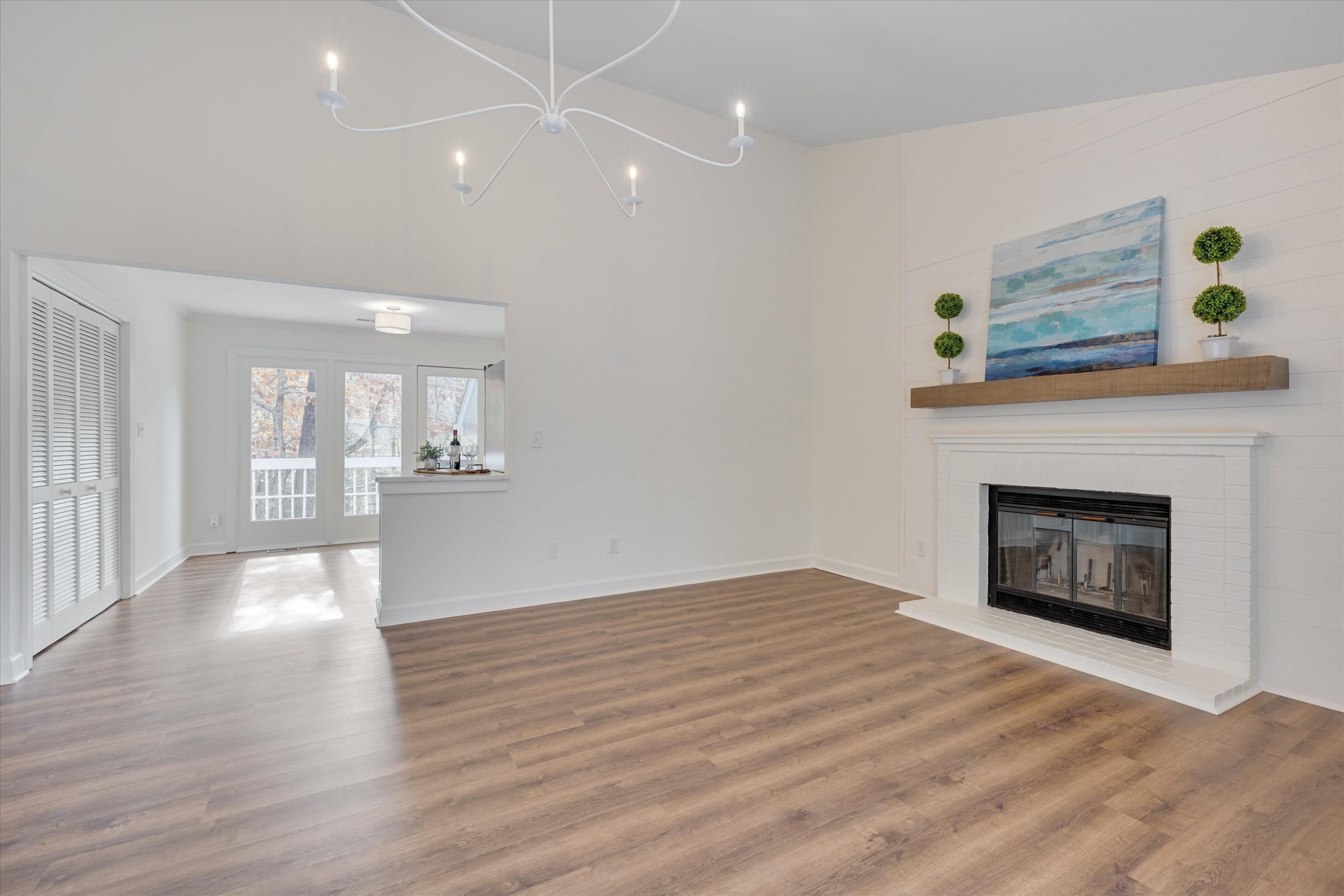 5500 Fortunes Ridge Drive, Unit 106D Durham, NC 27713 - Photo 9 of 30 a view of an empty room with wooden floor a fireplace and a window