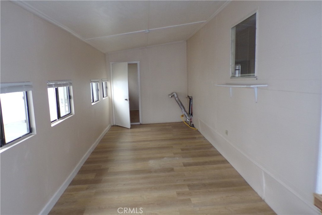 12710 3rd Street, Unit 57 Yucaipa, CA 92399 - Photo 2 of 13 a view of an entryway with wooden floor