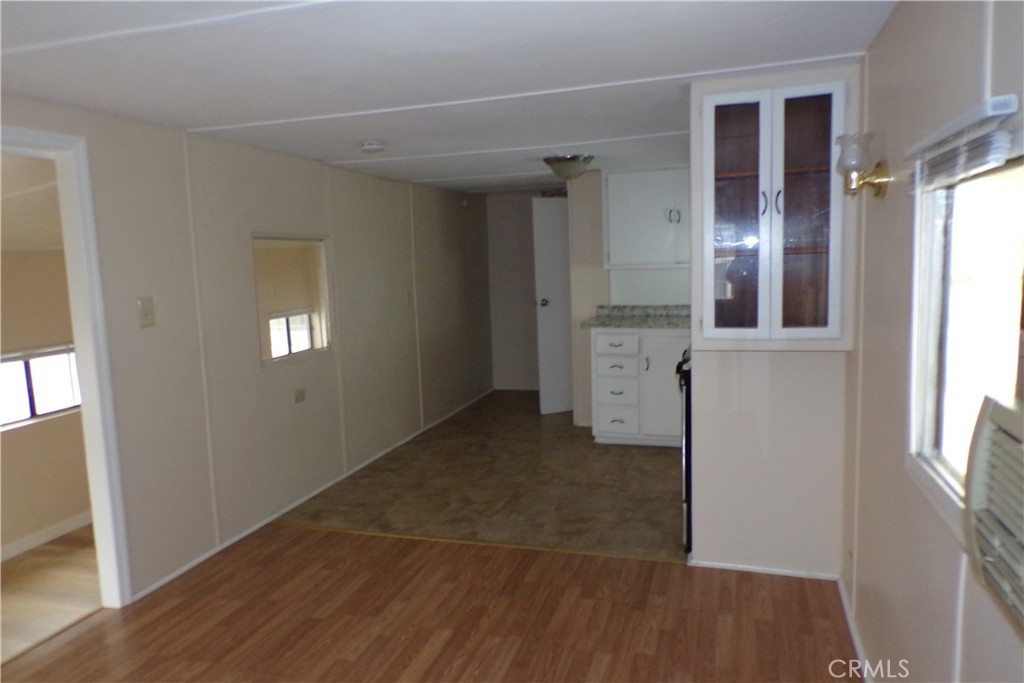 12710 3rd Street, Unit 57 Yucaipa, CA 92399 - Photo 7 of 13 an empty room with wooden floor and windows
