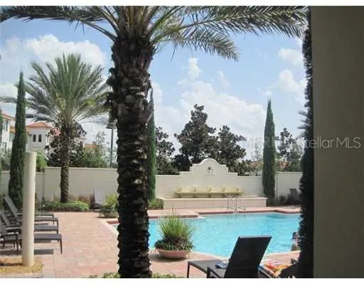 a view of swimming pool with a yard and seating area