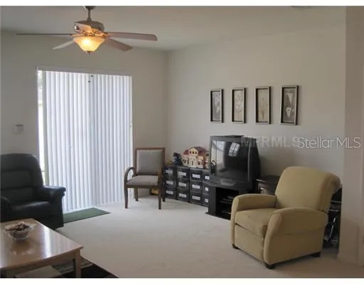 a living room with furniture and a lamp