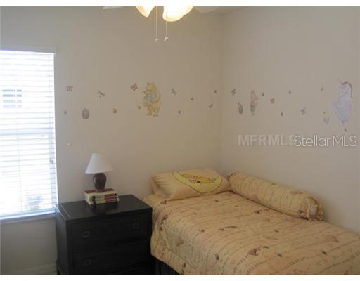 7351 Millstone Street Windermere, FL 34786 - Photo 7 of 15 a bedroom with a bed and a window