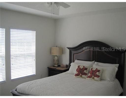 7351 Millstone Street Windermere, FL 34786 - Photo 8 of 15 a bedroom with a bed and wooden floor