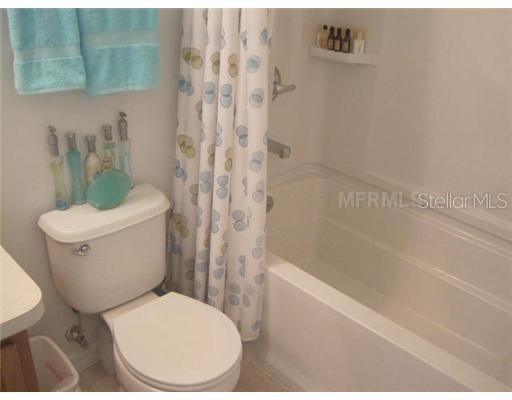 7351 Millstone Street Windermere, FL 34786 - Photo 10 of 15 a white toilet sitting next to a bath tub and a shower
