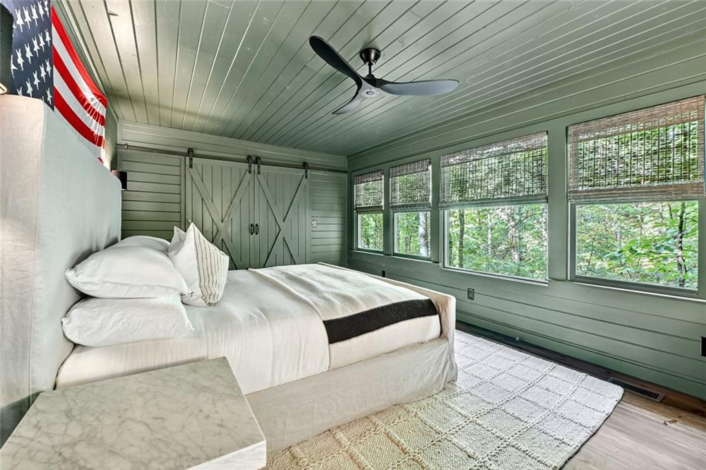 545 Chestnut Ridge Circle Blue Ridge, GA 30513 - Photo 16 of 34 a bedroom with a bed and a large window