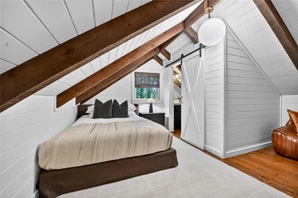a bed sitting in a room next to a window