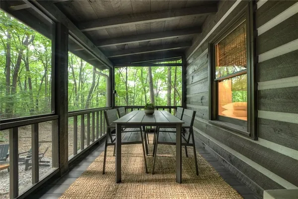 a view of a porch with furniture and wooden floor