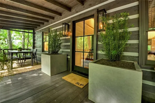 a living room with a floor to ceiling window and wooden floor