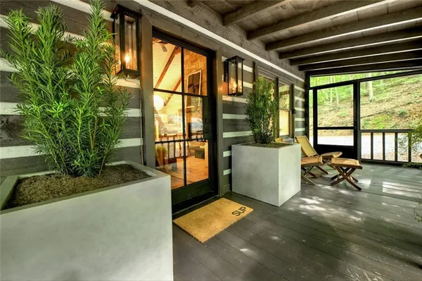 a view of a porch with furniture and floor to ceiling window