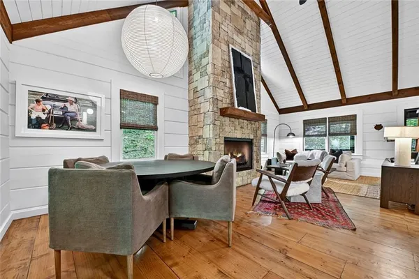 a living room with furniture a fireplace and a large window