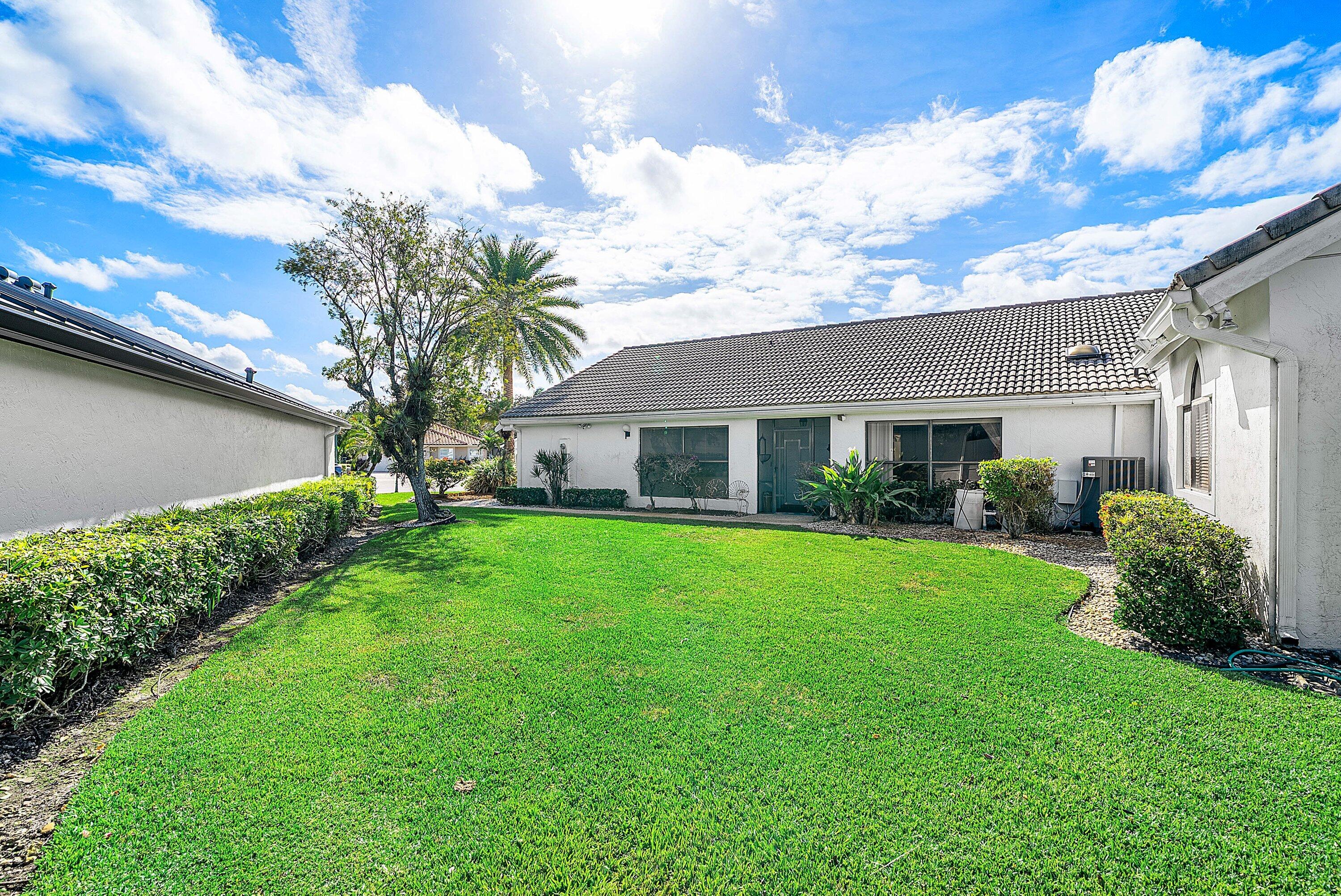 21459 Bridgeview Drive Boca Raton, FL 33428 - Photo 11 of 61 a front view of a house with a garden and plants