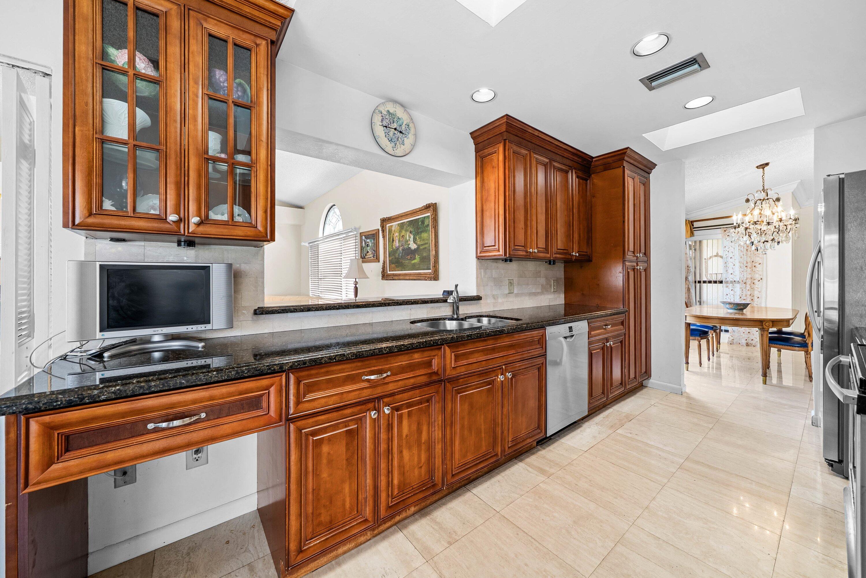 21459 Bridgeview Drive Boca Raton, FL 33428 - Photo 15 of 61 a kitchen with stainless steel appliances granite countertop a stove a sink and a microwave