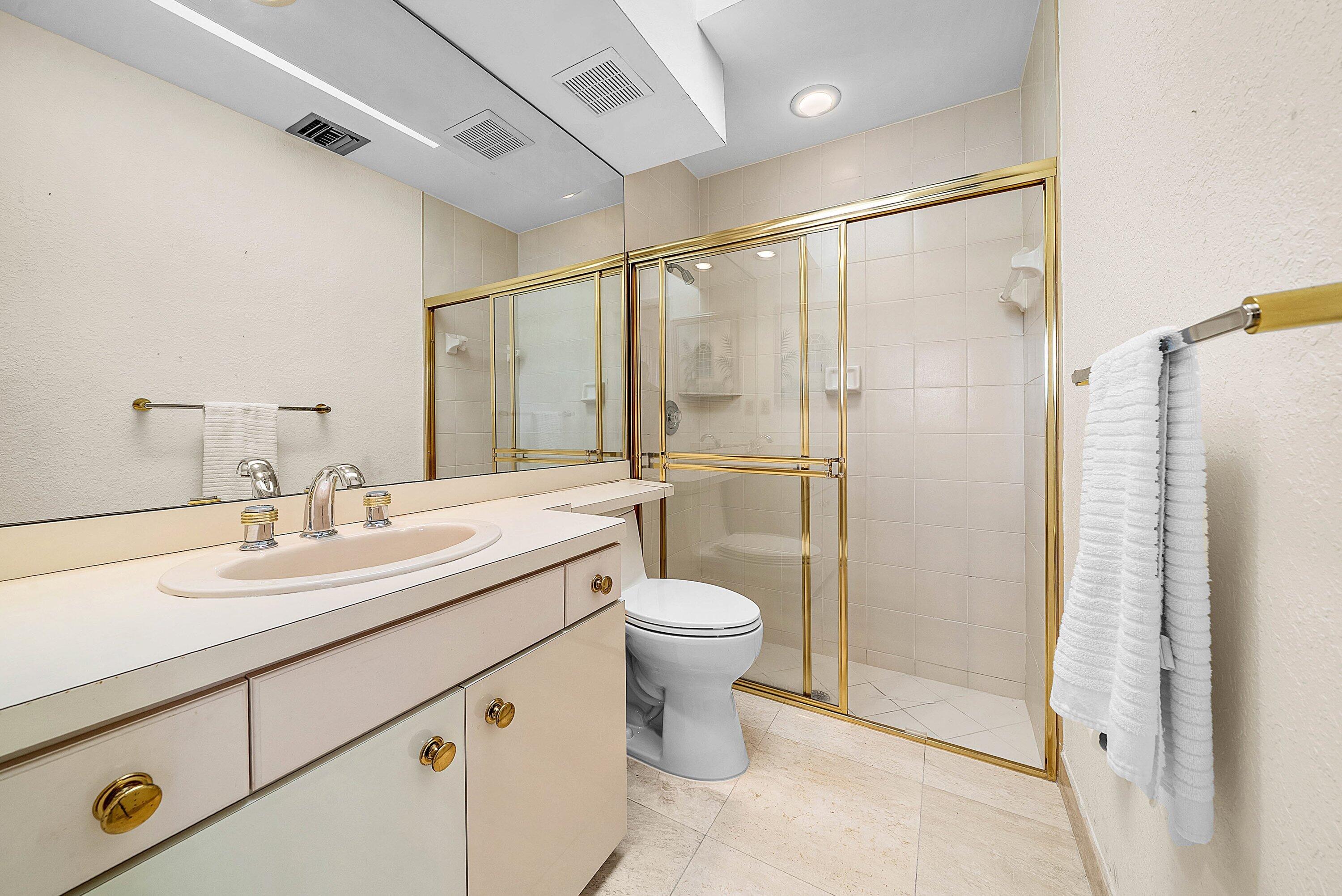 21459 Bridgeview Drive Boca Raton, FL 33428 - Photo 20 of 61 a bathroom with a double vanity sink toilet and shower