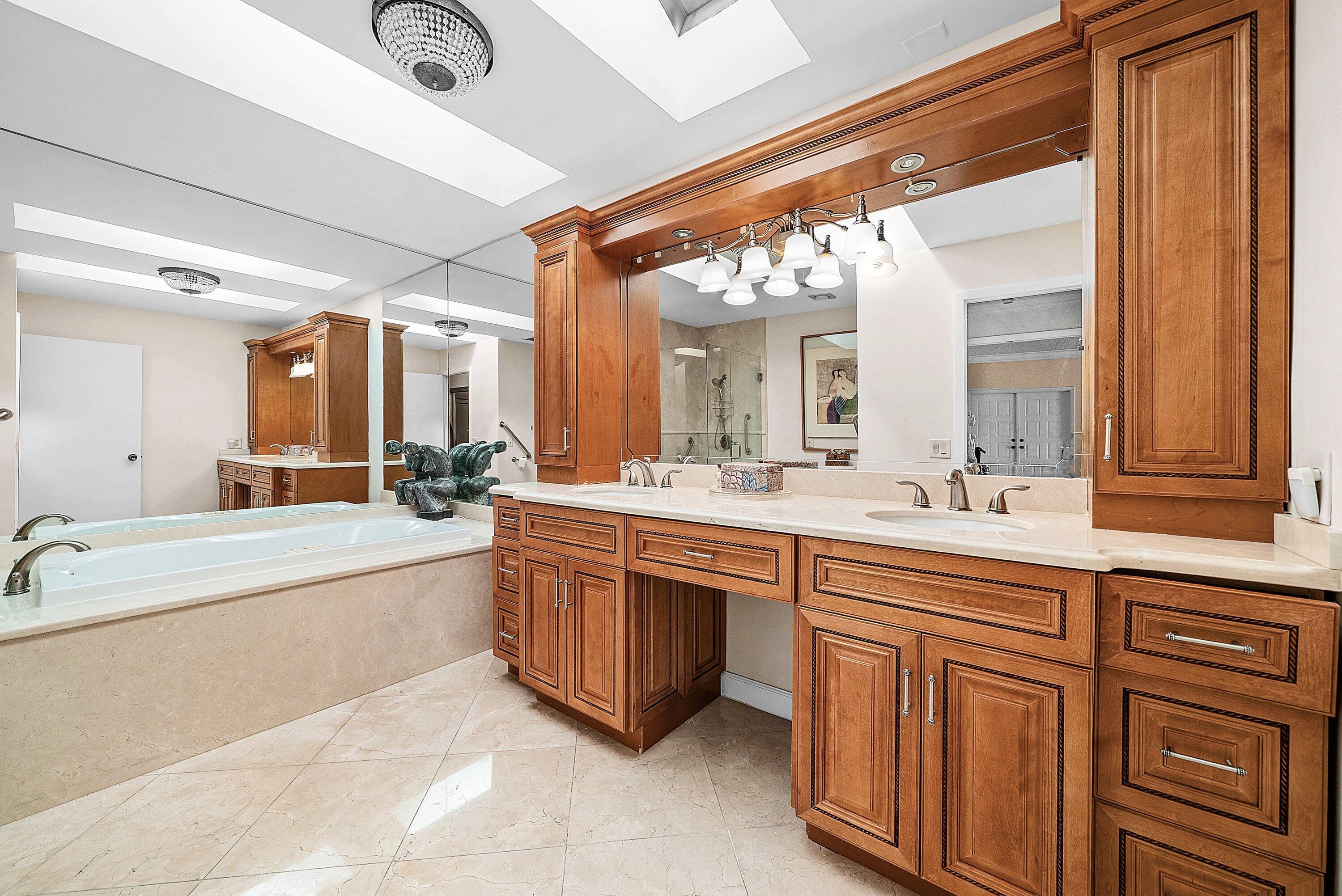 21459 Bridgeview Drive Boca Raton, FL 33428 - Photo 24 of 61 a large bathroom with a large tub and sink