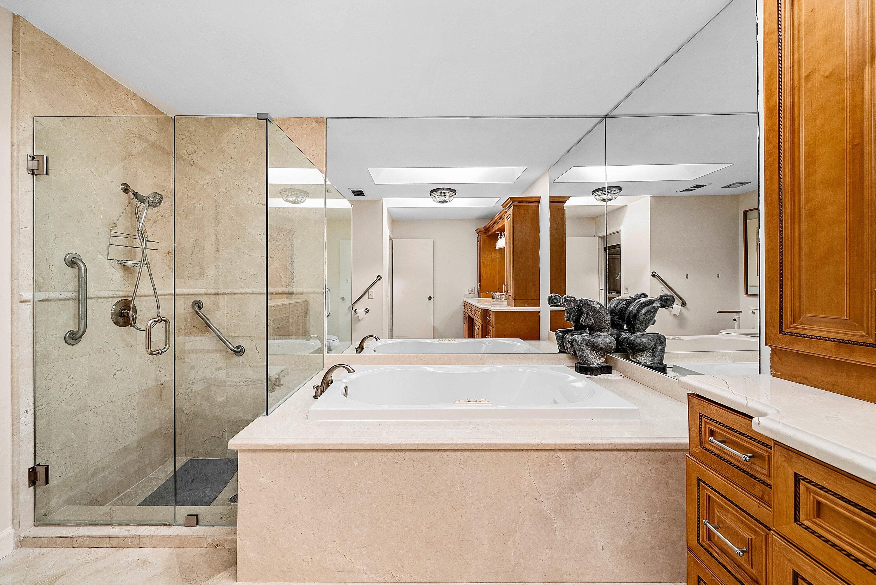 21459 Bridgeview Drive Boca Raton, FL 33428 - Photo 25 of 61 a bathroom with a sink and mirror with bathtub