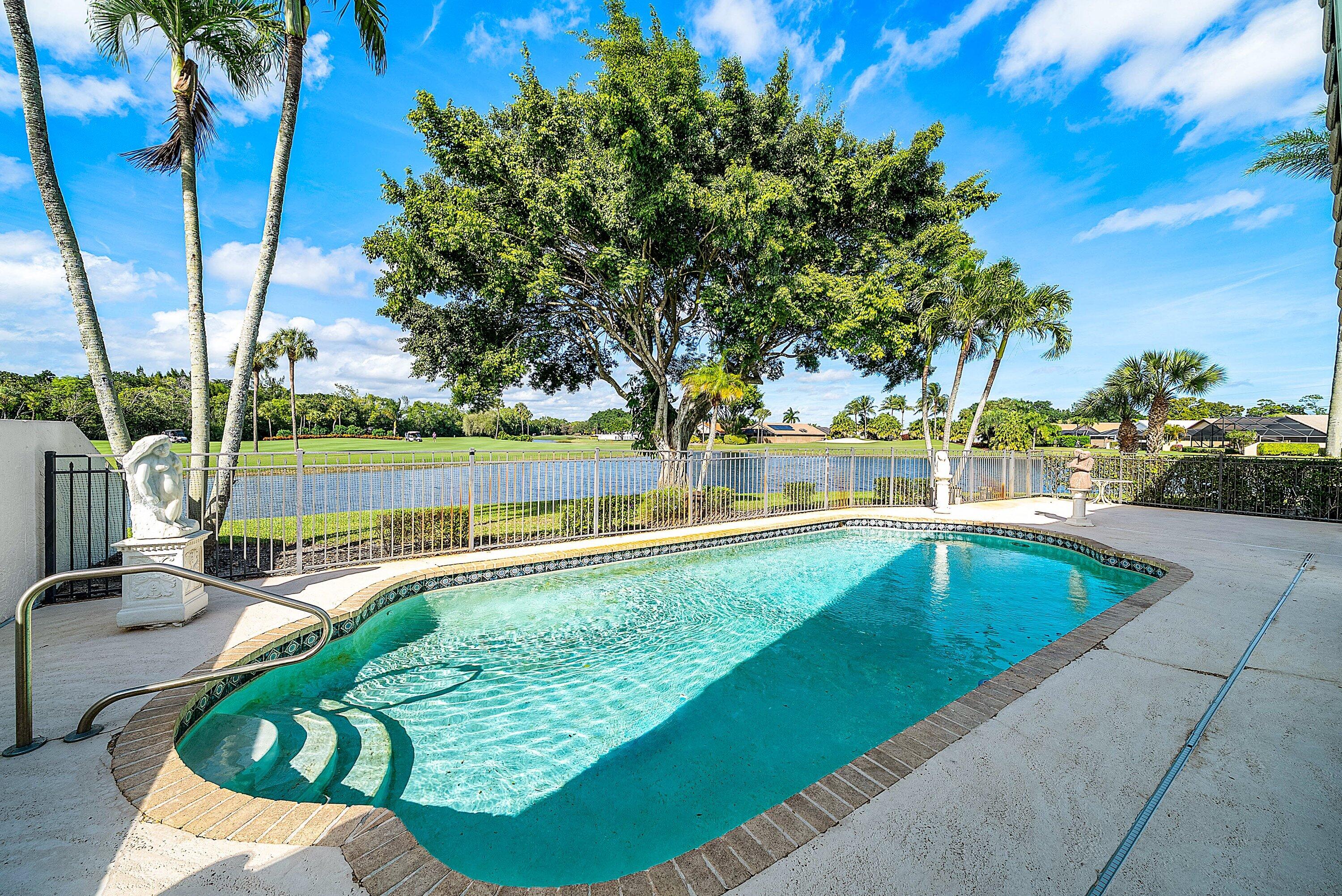 21459 Bridgeview Drive Boca Raton, FL 33428 - Photo 33 of 61 a view of a swimming pool with a patio and a yard