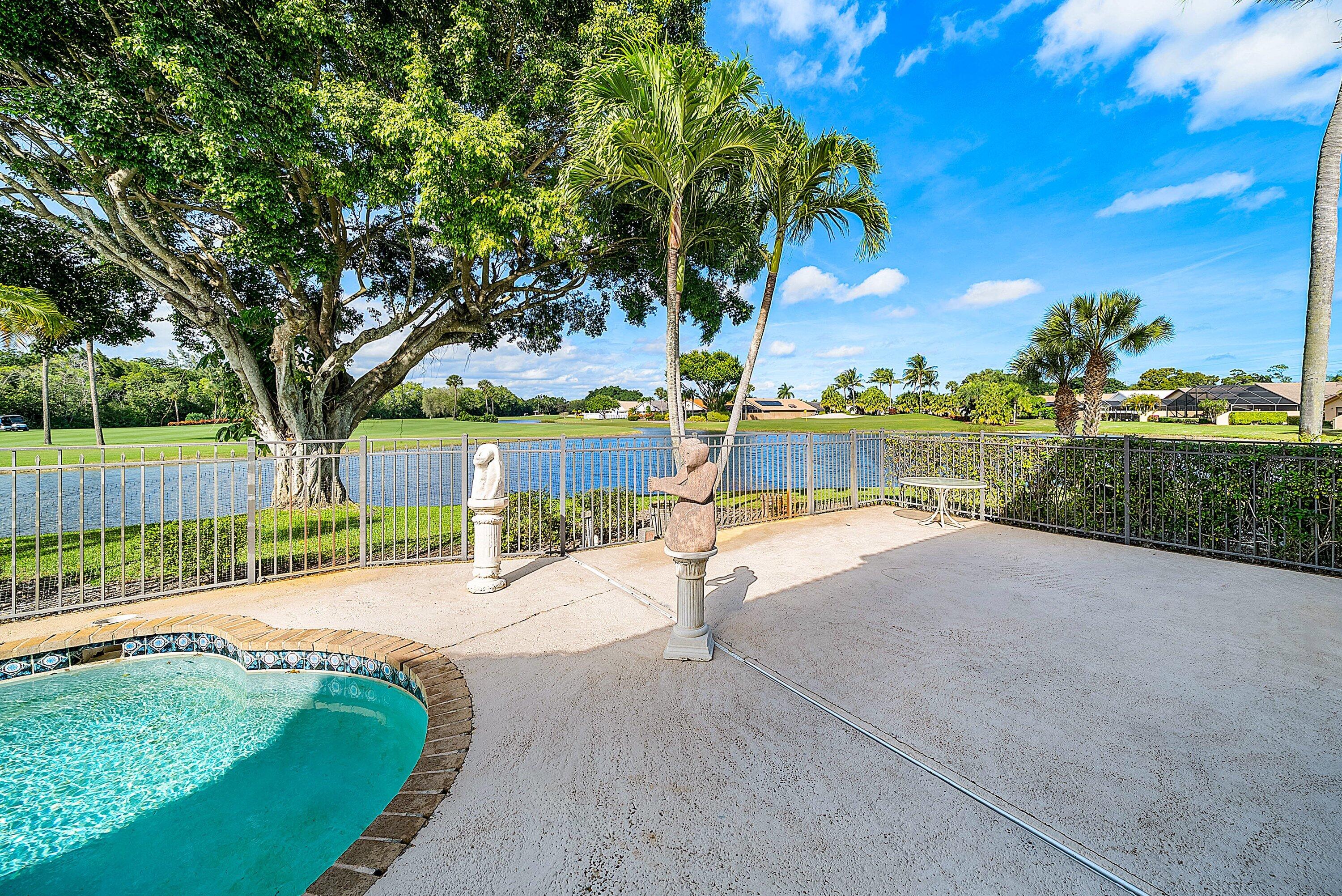 21459 Bridgeview Drive Boca Raton, FL 33428 - Photo 34 of 61 a view of a swimming pool with a patio and a yard