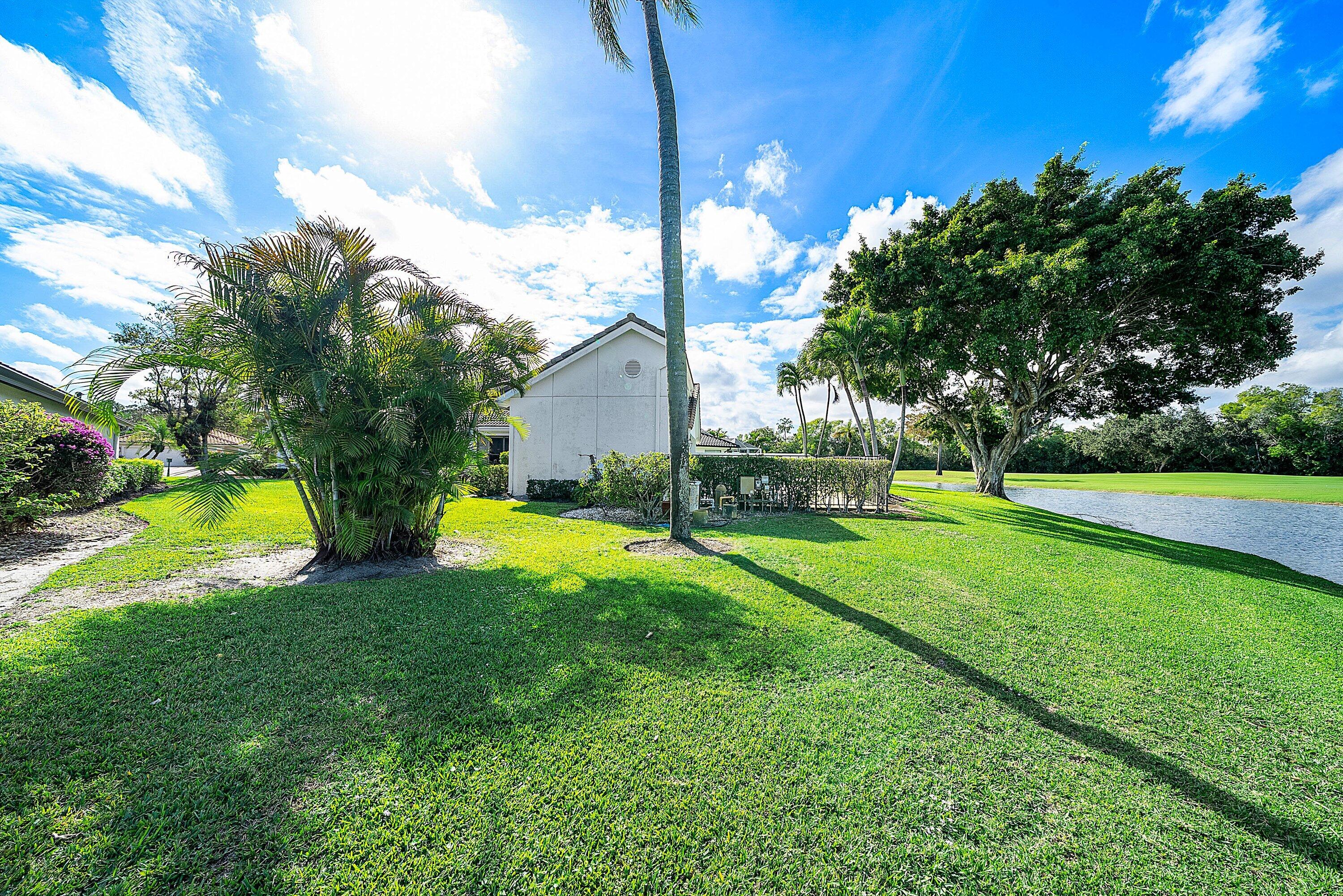 21459 Bridgeview Drive Boca Raton, FL 33428 - Photo 37 of 61 a view of a house with a big yard and palm trees